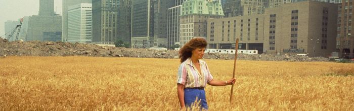 Agnes Denes, Wheatfield—A Confrontation: Battery Park Landfill, Downtown Manhattan, with Agnes Denes Standing in the Field, 1982. Courtesy the artist and Leslie Tonkonow Artworks + Projects, New York. Photo: John McGrall.